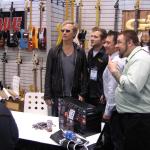 Jerry Cantrell posing with some fans during his signing session at the booth