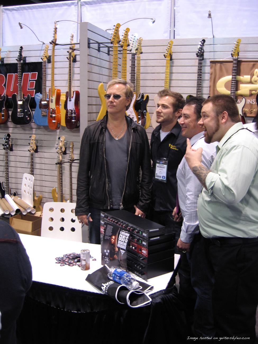 Jerry Cantrell posing with some fans during his signing session at the booth