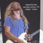 Standup poster on booth desk announcing Jerry Cantrell's appearance date and time