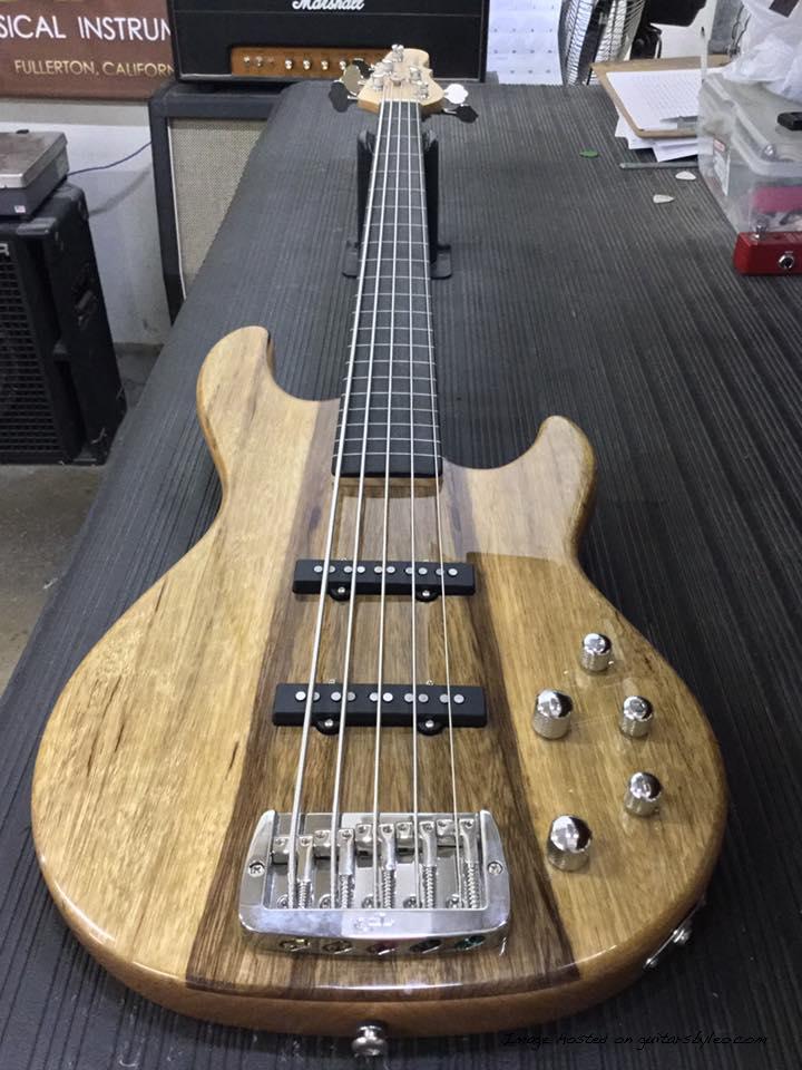 Fretless MJ-5 in Natural Gloss over black limba on swamp ash ebony board with white ghost lines