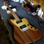 Doheny made of oiled Monkeypod with a roasted Flame Maple neck and gold anodized aluminum pickguard