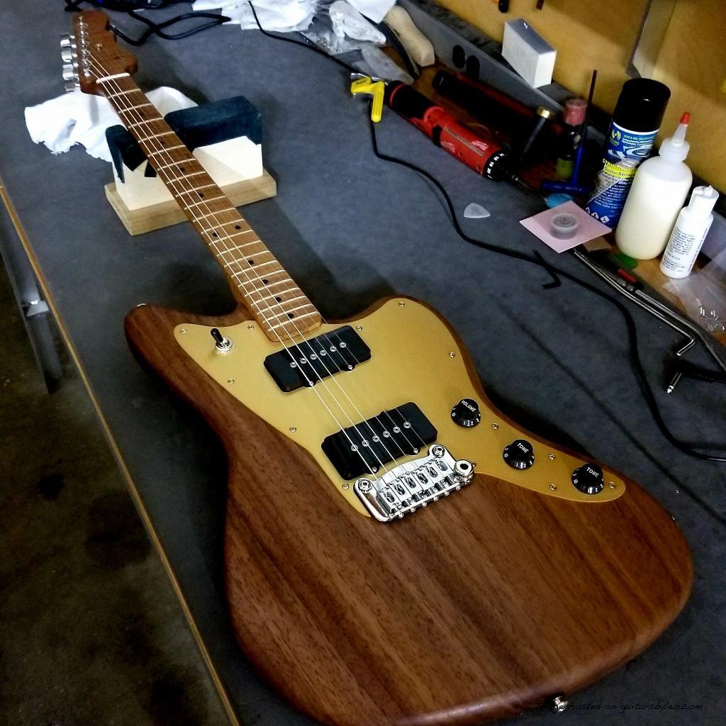 Doheny made of oiled Monkeypod with a roasted Flame Maple neck and gold anodized aluminum pickguard