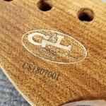Closeup detail of a Roasted Maple neck with a Quilted Maple logo insert